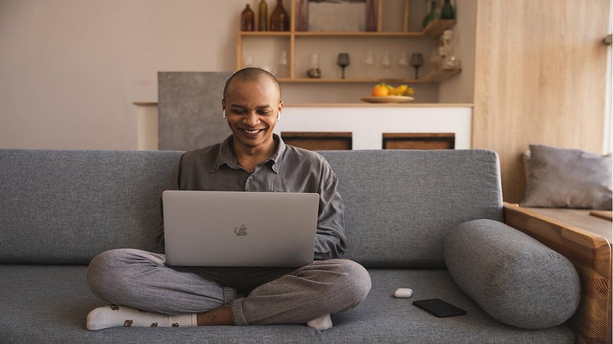 Guardian looks up admission regulations online using laptop