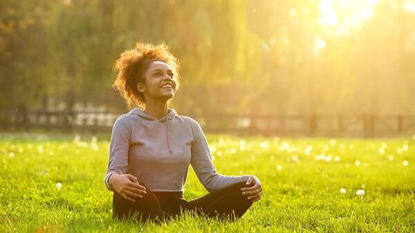 An unemployed woman practices self-care in her garden